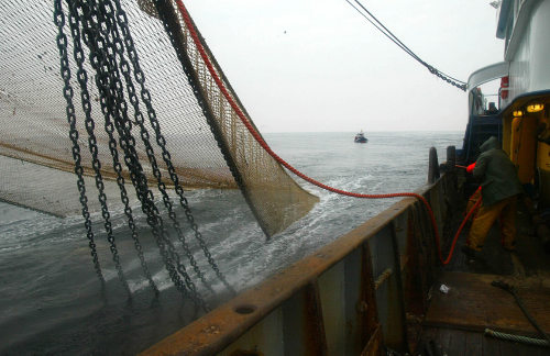Un barco recogiendo las redes