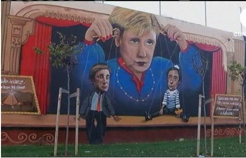 Un cartel alusivo a Angela Merkel