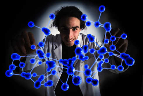un científico mostrando la representación de un átomo