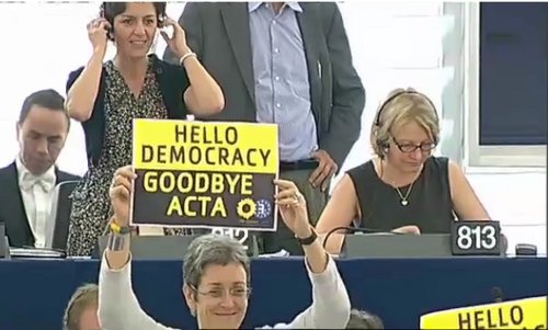 Una europarlamentaria muestra una pancarta que dice 