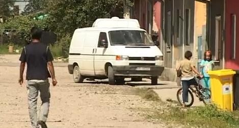 Unos niños junto a una furgoneta aparcada en un campamento gitano en Francia