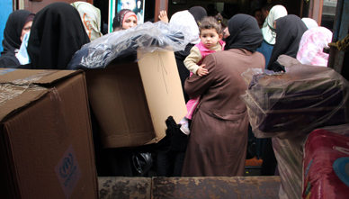 Mujeres sirias reciben cajas de ayuda