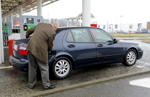 Un hombre pone combustible en su coche